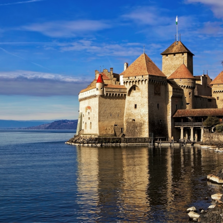 castle by the sea under blue sky